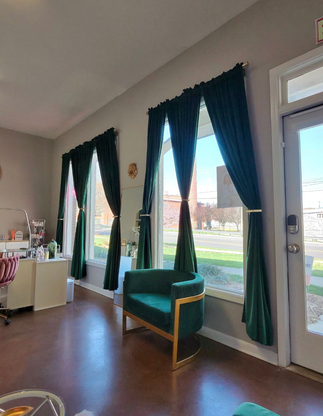 Reception area at Mod Esthetics with a green chair placed under a bright window.
