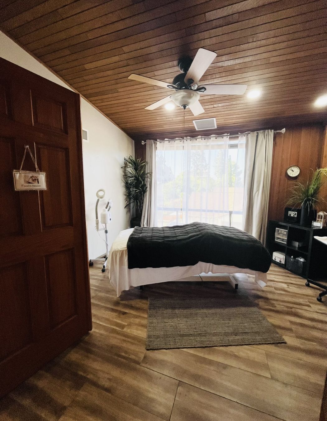 Peaceful treatment space set up with a brown-blanketed table ready for a session