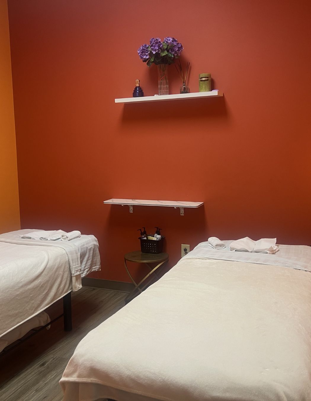 Spa treatment room at Taichi Spa in San Antonio, Texas, featuring two massage tables arranged for dual treatments in a serene setting.