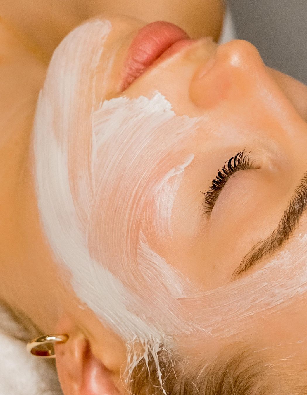 Woman with bright clear skin enjoying facial treatment