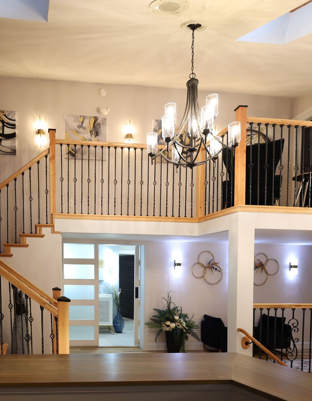 Aerial view of a tranquil hallway area at Elysian Spa at In Vogue in Oswego, New York with wood floors and soft lighting.