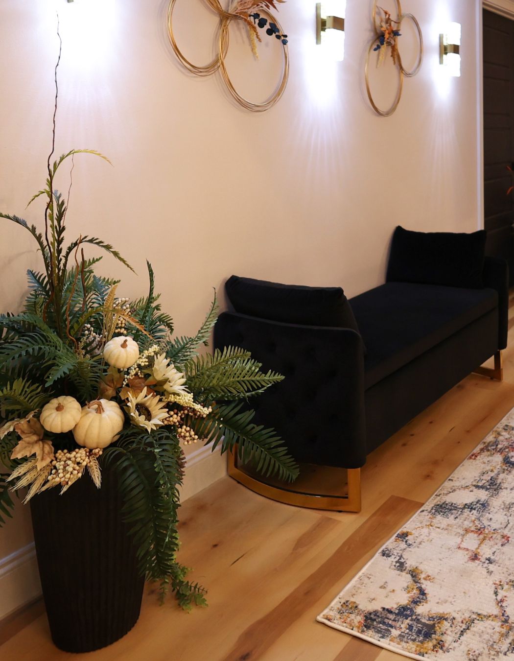 Close-up of a cozy sofa in the hallway of Elysian Spa at In Vogue in Oswego, New York, providing a comfortable seating area near the treatment rooms.