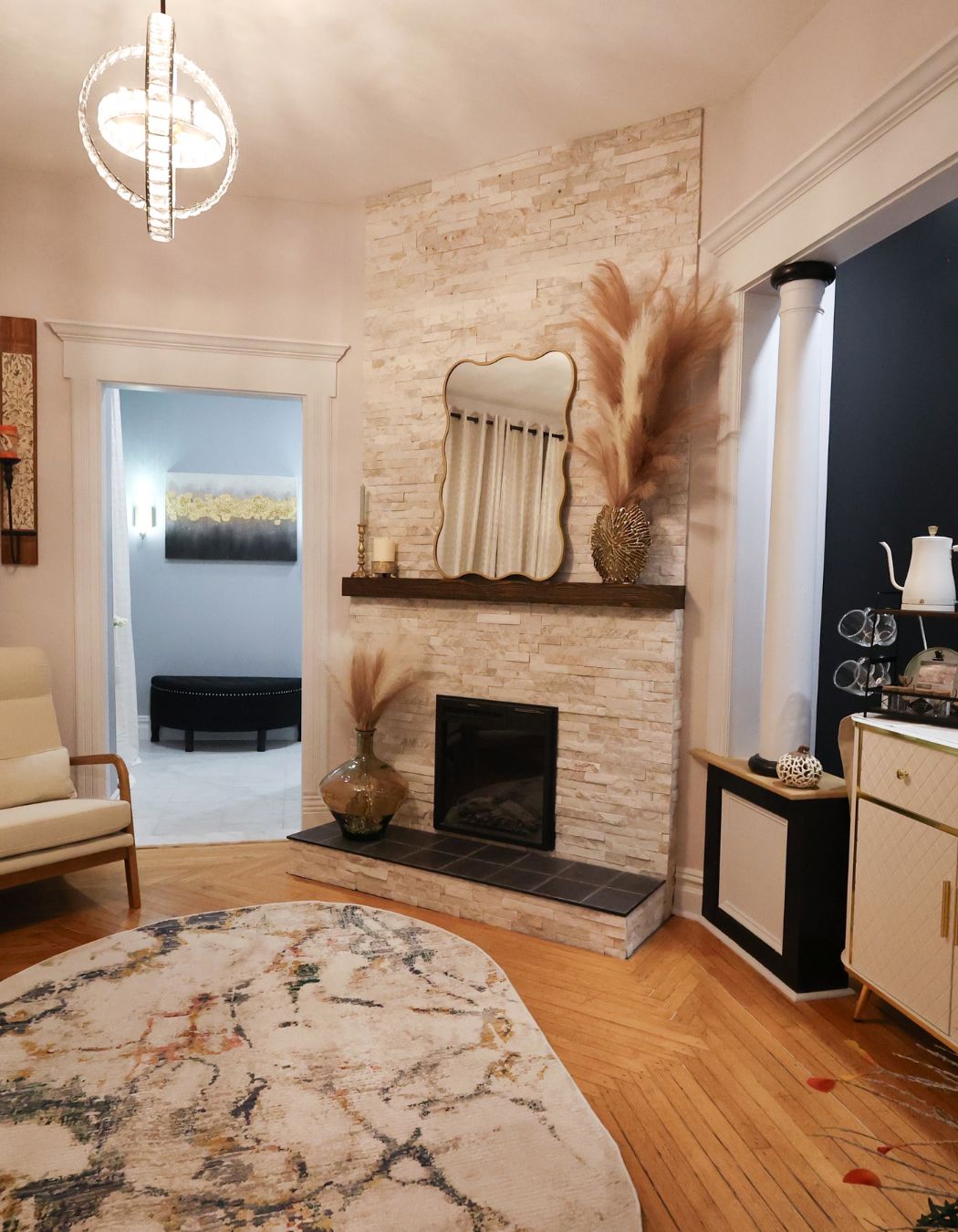 Relaxation lounge with fireplace, wood floors, and seating at Elysian Spa at In Vogue in Oswego, New York.