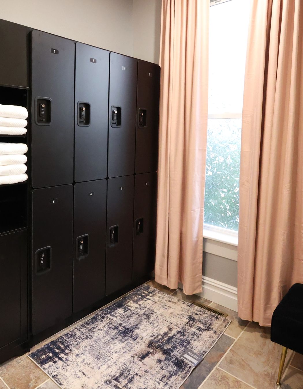 Guest locker area at Elysian Spa at In Vogue in Oswego, New York, with natural light and secure storage for personal items during spa treatments.