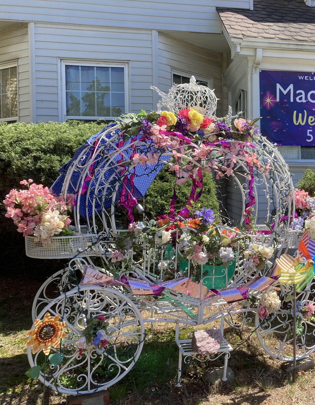 Fairytale Cinderella carriage adorned with flowers outside a luxury day spa, creating a romantic, storybook entrance.
